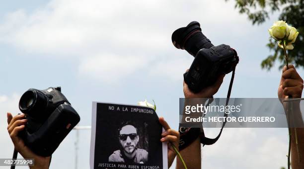 Mexican photojournalists hold a picture of murdered colleague Ruben Espinosa during a demonstration in Guadalajara City, on August 2, 2015. Espinosa...