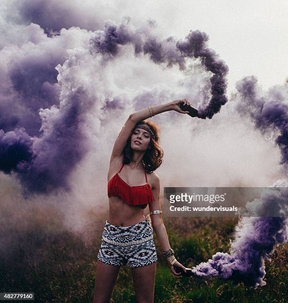 hippie girl dancing in a park with purple smoke - smoking girl 個照片及圖片檔
