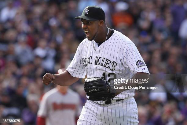 Starting pitcher Juan Nicasio of the Colorado Rockies reacts to a defensive play by second baseman DJ LeMahieu of the Colorado Rockies to end the top...