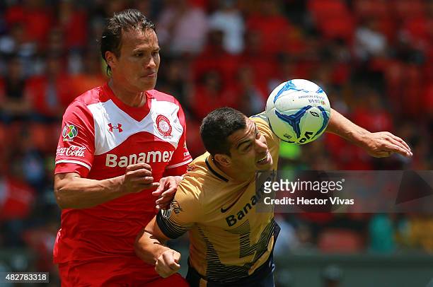 Aaron Galindo of Toluca fights for the ball with Gerardo Alcoba of Pumas during a 2nd round match between Toluca and Pumas UNAM as part of the...