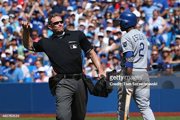 Home plate umpire Jim Wolf ejects Aaron Sanchez of the Toronto Blue Jays after hitting Alcides Escobar of the Kansas City Royals in the eighth inning...