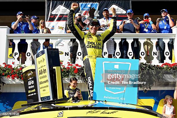 Matt Kenseth, driver of the Dollar General Toyota, celebrates in Victory Lane after winning the NASCAR Sprint Cup Series Windows 10 400 at Pocono...