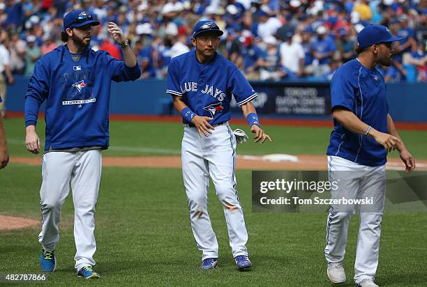 Munenori Kawasaki of the Toronto Blue Jays dances after their victory during MLB game action against the Kansas City Royals on August 2, 2015 at...