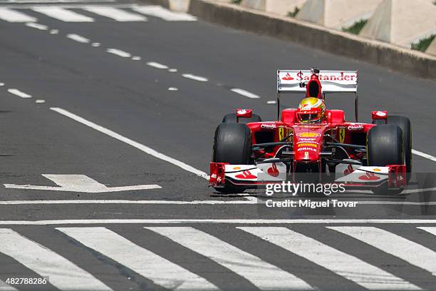 Mexican driver of F1 Esteban Gutierrez drives during the Scuderia Ferrari Street Demo at Reforma Avenue on August 02, 2015 in Mexico City, Mexico.