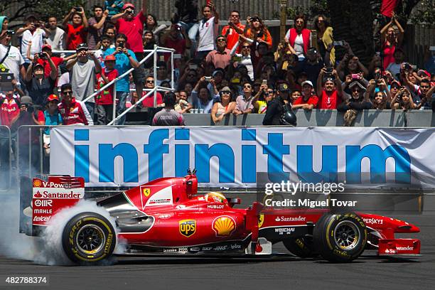 Mexican driver of F1 Esteban Gutierrez drives during the Scuderia Ferrari Street Demo at Reforma Avenue on August 02, 2015 in Mexico City, Mexico.