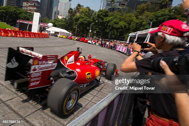 Mexican driver of F1 Esteban Gutierrez drives during the Scuderia Ferrari Street Demo at Reforma Avenue on August 02, 2015 in Mexico City, Mexico.