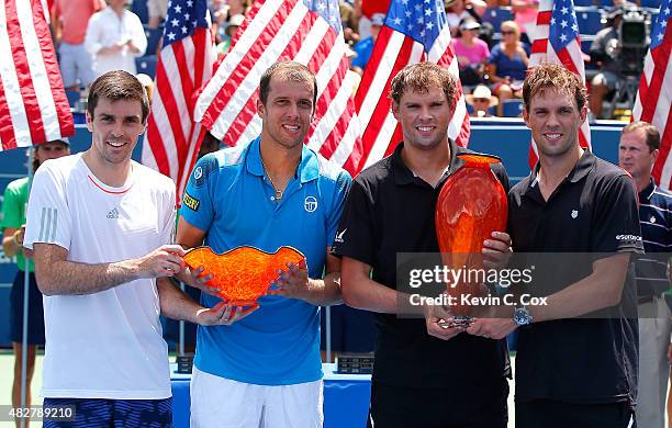 Gilles Muller of Luxembourg, Colin Fleming and Great Britain, and Bob and Mike Bryan pose with their trophies after defeating during the BB&T Atlanta...