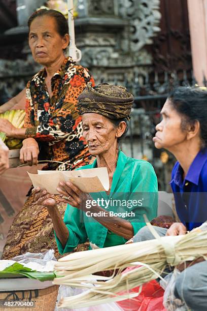 senior indonesian women working in street market preparing local cuisine - indonesia street market stock pictures, royalty-free photos & images