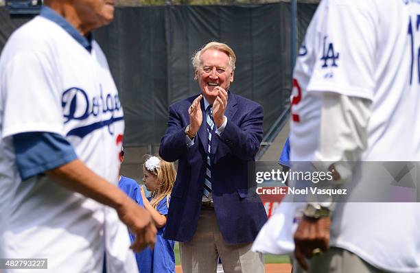 Vin Scully applauds Dodger hall of famers during opening day pre game ceremonies at a baseball game between the San Fransico Giants and the Los...