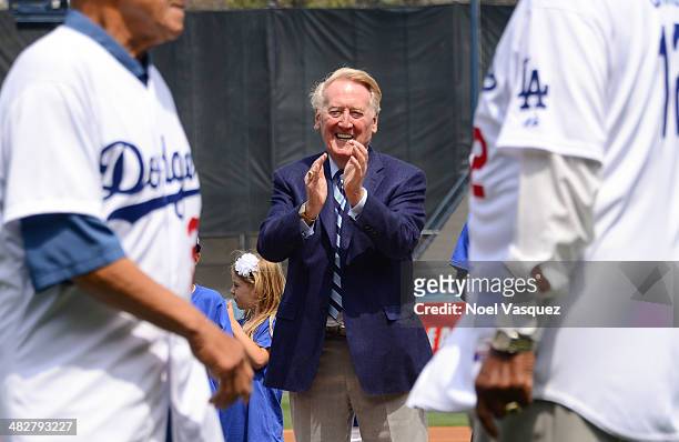 Vin Scully applauds Dodger hall of famers during opening day pre game ceremonies at a baseball game between the San Fransico Giants and the Los...