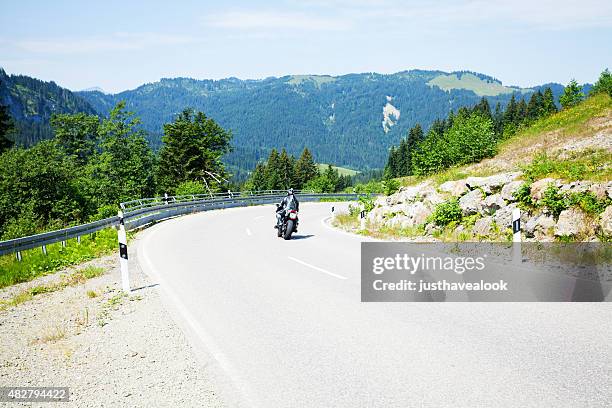 biker entering curve of road oa9 in oberallgäu - bavaria bike stock pictures, royalty-free photos & images