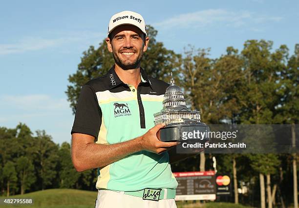 Troy Merritt holds the championship trophy after winning the Quicken Loans National at the Robert Trent Jones Golf Club on August 2, 2015 in...