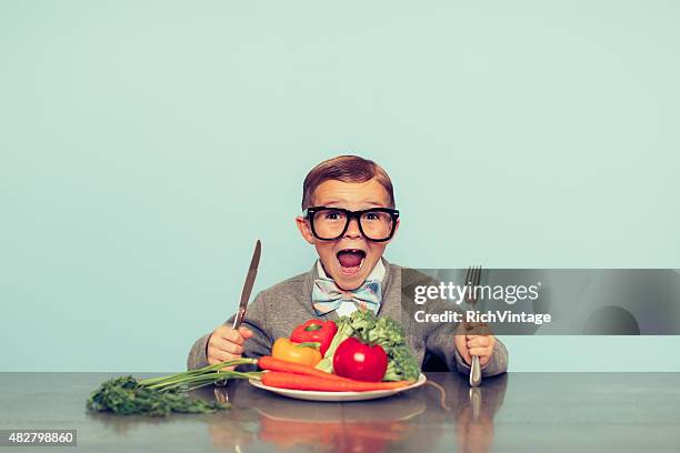 young nerd boy loves eating vegetables - funny vegetable stockfoto's en -beelden