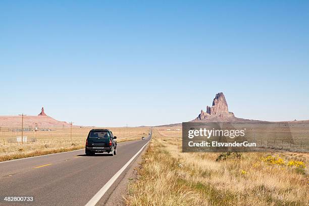 driving through monument valley - low angle desert road stock pictures, royalty-free photos & images