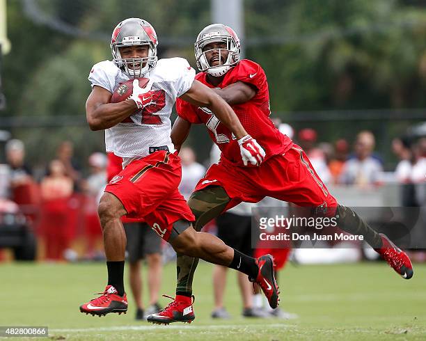 Running back Doug Martin of the Tampa Bay Buccaneers catches a pass over corner back Alterraun Verner during Training Camp at One Buc Place on August...