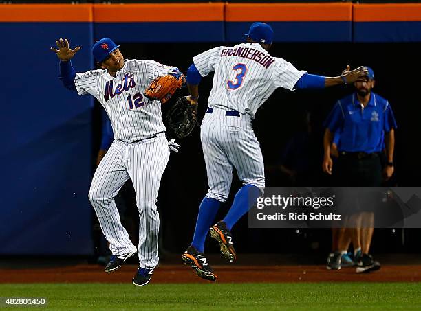 Outfielders Juan Lagares and Curtis Granderson of the New York Mets celebrate after defeating the Washington Nationals 5-2 on August 2, 2015 at Citi...