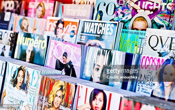 american magazines displayed for sale on newsstand - news stand stock pictures, royalty-free photos & images