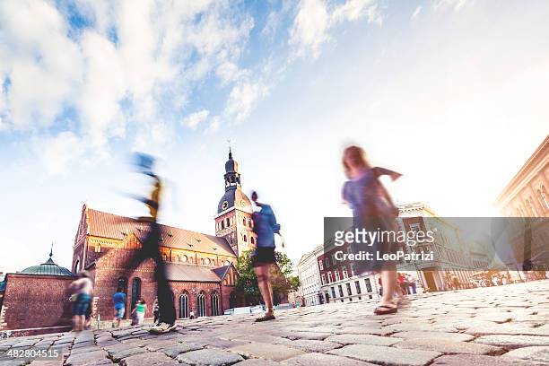 people and riga dome at dusk - riga stock pictures, royalty-free photos & images
