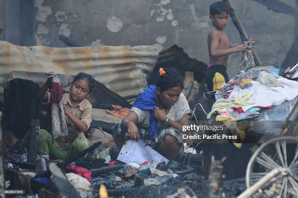 The fire victims salvaging things from the debris of fire...