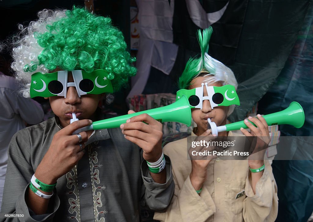 Vendors wearing a green wig and a green small trumpet for...