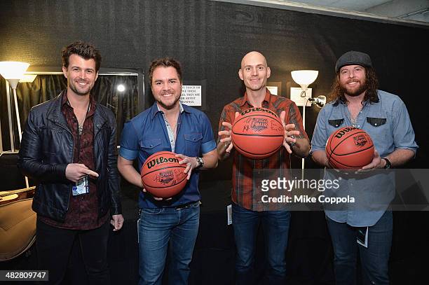 Chris Thompson, Mike Eli, Jon Jones and James Young of Eli Young Band pose backstage during the AT&T Block Party at NCAA March Madness Music Festival...