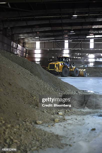 Dump truck stands behind a stockpile of copper concentrate in a shed at the Sandfire Resources NL copper operations at DeGrussa, Australia, on...