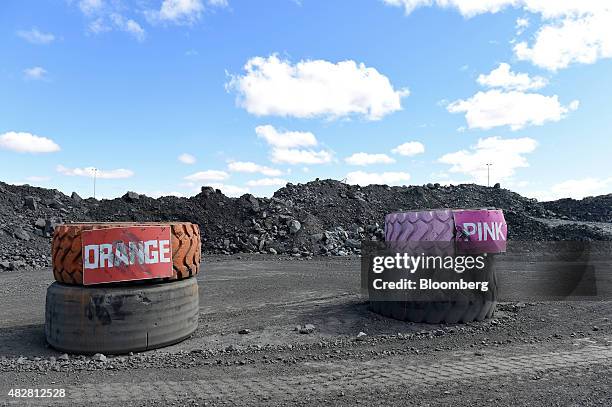 Tires marked with different colors denoting different grades of ore deposits stand at the Sandfire Resources NL copper operations at DeGrussa,...