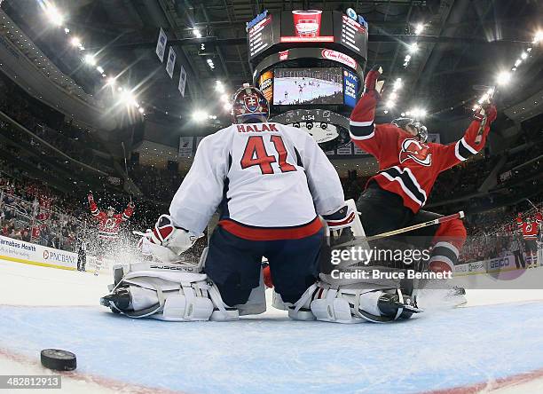 Ryan Carter of the New Jersey Devils scores the game winning goal at 15:06 of the third period against Jaroslav Halak of the Washington Capitals at...