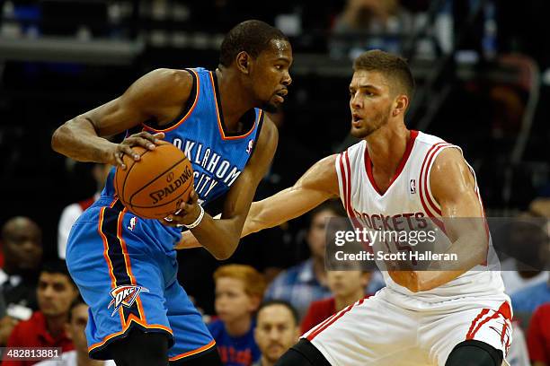 Kevin Durant of the Oklahoma City Thunder drives to the basket against Chandler Parsons of the Houston Rockets during a game at the Toyota Center on...