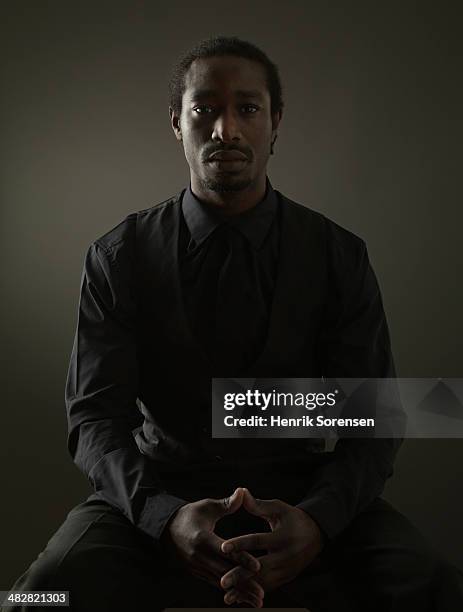 portrait of a black man on a dark background - 手を重ねる ストックフォトと画像