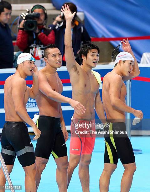 Takuro Fujii, Shinri Shioura, Katsumi Nakamura and Yuki Kobori of Japan react after competing in the Men's 400m Freestyle Relay Premilimary during...