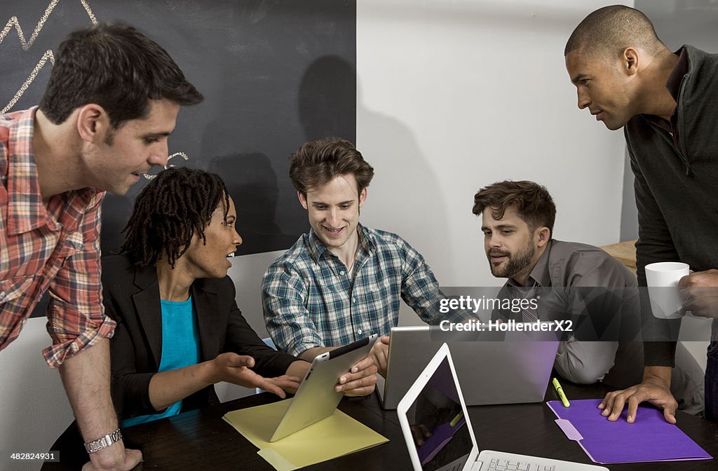 Young adults using technology in office