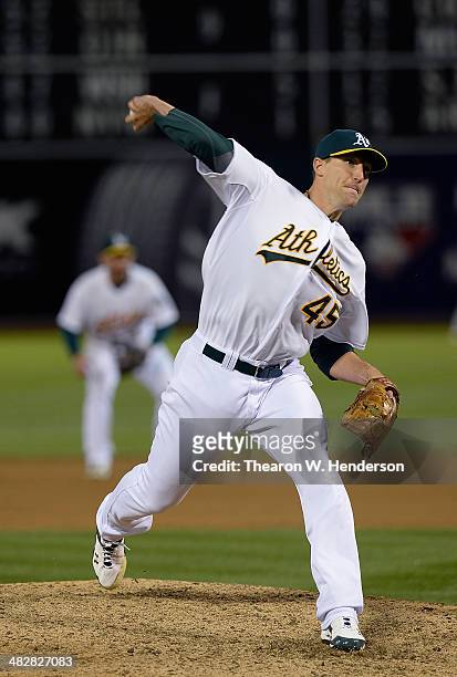 Jim Johnson of the Oakland Athletics pitches against the Cleveland Indians during the ninth inning at O.co Coliseum on April 2, 2014 in Oakland,...