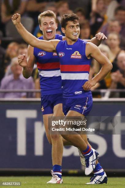 Luke Dahlhaus of the Bulldogs celebrates a goal with Lachie Hunter during the round three AFL match between the Western Bulldogs and the Richmond...