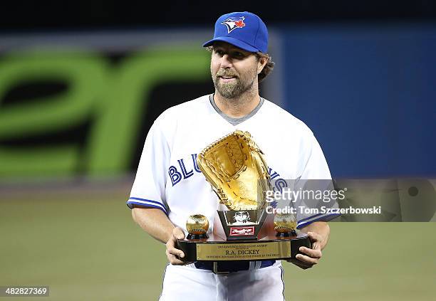 Dickey of the Toronto Blue Jays is presented with the Gold Glove award before the start of MLB game action against the New York Yankees on April 4,...
