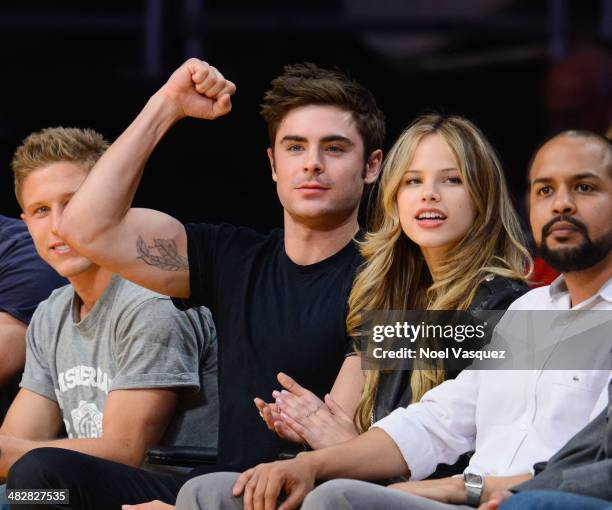 Zac Efron and Halston Sage attend a basketball game between the Dallas Mavericks and the Los Angeles Lakers at Staples Center on April 4, 2014 in Los...