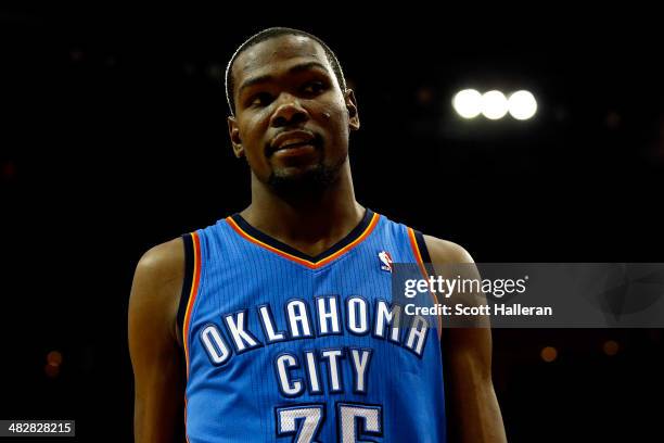 Kevin Durant of the Oklahoma City Thunder looks on against the Houston Rockets during a game at the Toyota Center on April 4, 2014 in Houston, Texas....