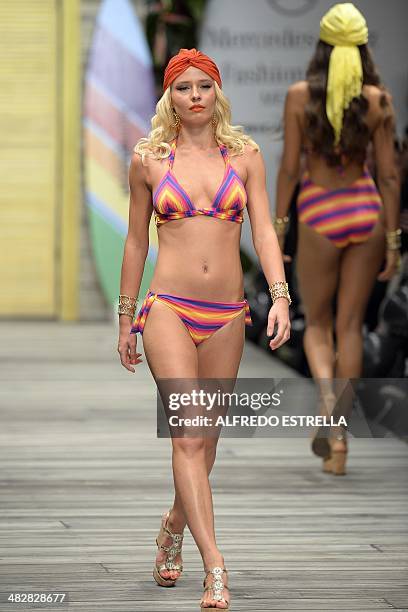 Model displays a creation by Colombian Zingara swimwear during the Autumn-Winter Mexican Fashion Week on April 04, 2014 in Mexico city. AFP...