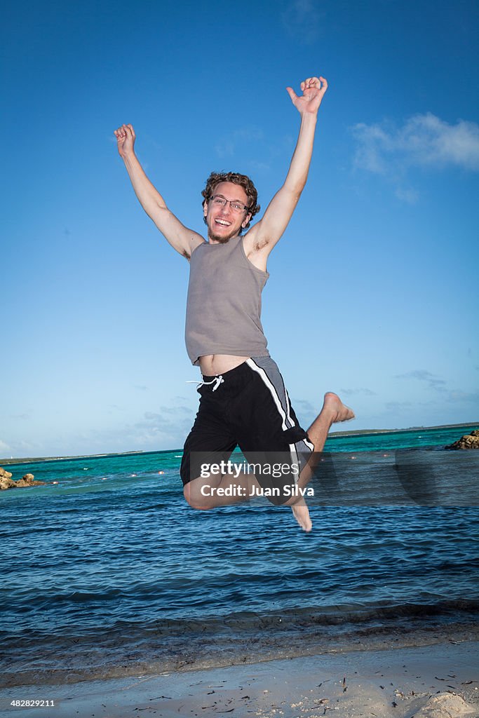 Young man jumping on the beach