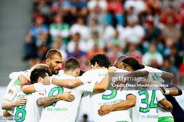 Bas Dost of VfL Wolfsburg and team mates speak prior to the DFL Supercup match between VfL Wolfsburg and FC Bayern Muenchen at Volkswagen Arena on...