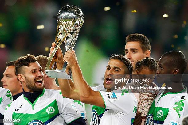 Ricardo Rodriguez of VfL Wolfsburg lifts the trophy after winning the DFL Supercup match between VfL Wolfsburg and FC Bayern Muenchen at Volkswagen...