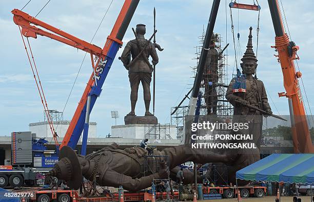 Thai workers prep and install statues of Thai kings at Ratchapakdi Park in Prachuap Khiri Khan province on August 3, 2015. The statues are part of an...