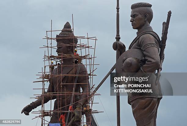 Thai workers put final touches on the statue of King Ramkhamhaeng , seen next to the statue of King Naresuan , at Ratchapakdi Park in Prachuap Khiri...