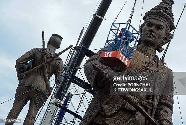 Thai workers put final touches on statues of Thai kings at Ratchapakdi Park in Prachuap Khiri Khan province on August 3, 2015. The statues are part...