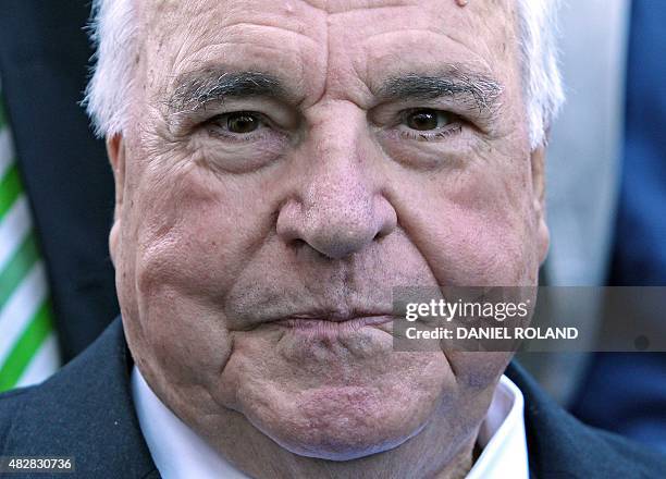 Former German Chancellor Helmut Kohl arrives at the book fair in Frankfurt, central Germany, where he presented a photo book about him on October 8,...