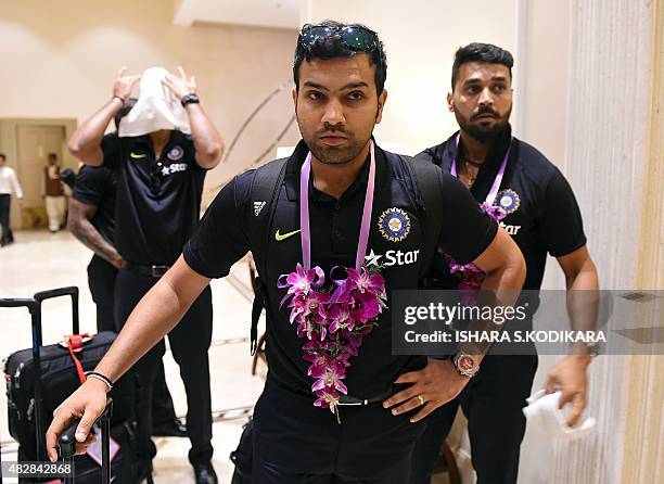 Indian cricketers Rohit Sharma and Murali Vijay arrive at a hotel in Colombo on August 3, 2015. India will play three Test series matches in Sri...