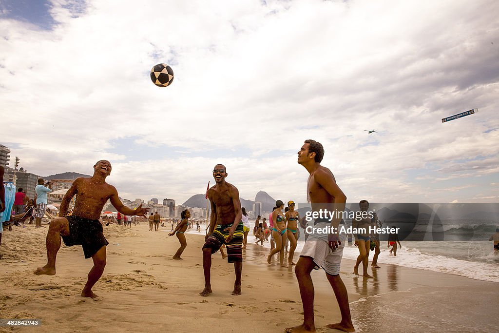 People playing soccer outside on Ipanema Beach.