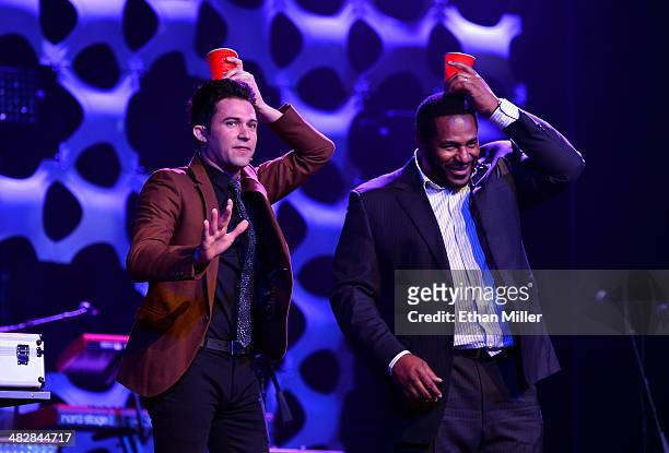 Entertainer Justin Willman performs a magic trick with former National Football League player Jerome Bettis at the 13th annual Michael Jordan...
