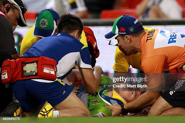 Joel Edwards of the Raiders is attended to by team trainers after a heavy tackle during the round five NRL match between the Penrith Panthers and...