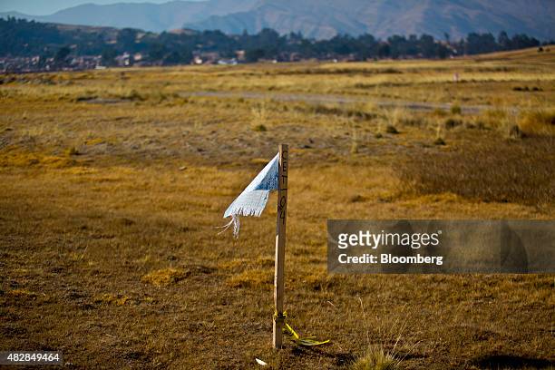 Flag marks a newly allotted property in Chinchero, Peru, on Thursday, July 30, 2015. The Kuntur Wasi consortium, comprised of the Argentine holding...
